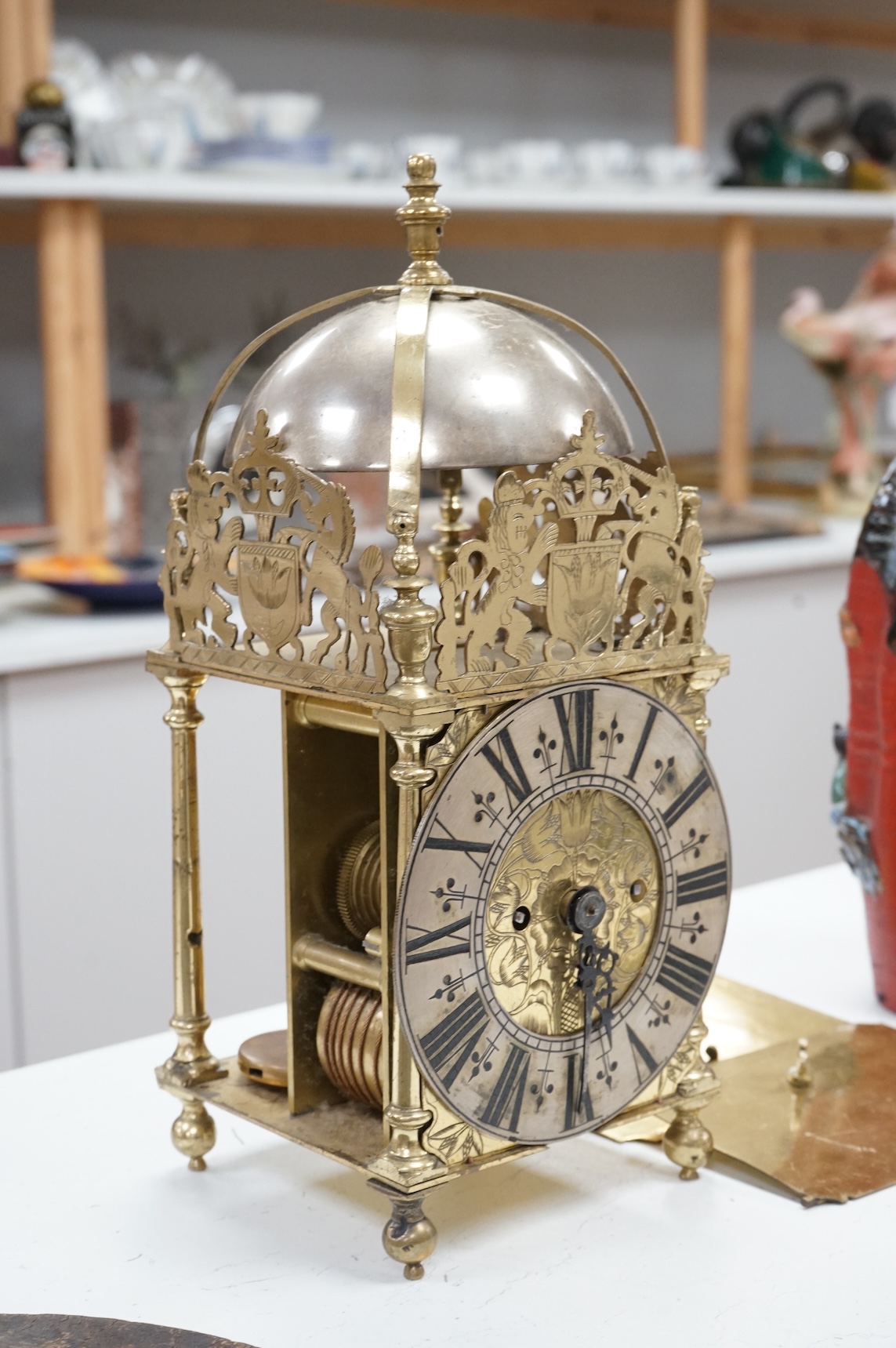 A twin fusee brass lantern clock, 38cm high.